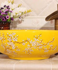 Top Tier Yellow Floral Ceramic Vessel Sink For Bathroom Countertop Featuring Handmade Artistry Slick Craftsmanship No Fuss Install With Center Drain And Fresh Vibes To Level Up Your Bathroom. Round ceramic vessel sink with floral design.