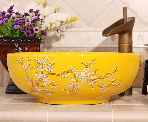 Top Tier Yellow Floral Ceramic Vessel Sink For Bathroom Countertop Featuring Handmade Artistry Slick Craftsmanship No Fuss Install With Center Drain And Fresh Vibes To Level Up Your Bathroom. Round ceramic vessel sink with floral design.