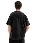 Back view of person wearing a black washed T-shirt with short sleeves and loose fit, casual style.