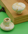 10 Pack Handcrafted Ceramic Cabinet Knobs Featuring Gorgeous Granite Marble Finish top view with yellow veining and solid build.