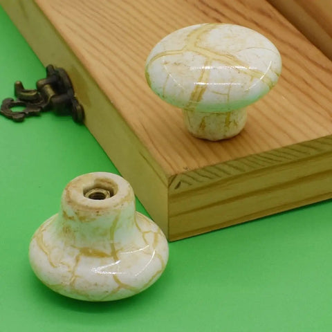 10 Pack Handcrafted Ceramic Cabinet Knobs Featuring Gorgeous Granite Marble Finish top view with yellow veining and solid build.