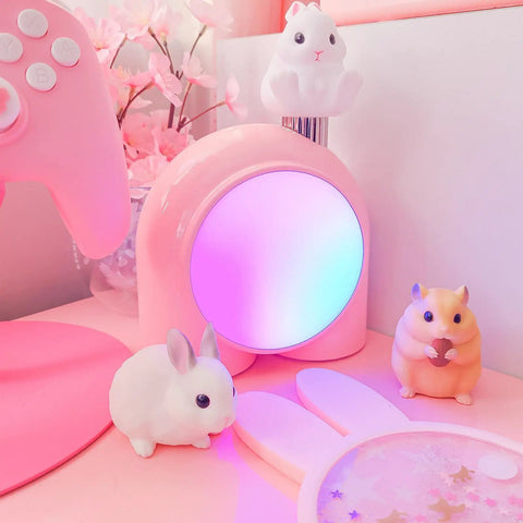 Planet 9 Smart Mood Lamp Battery Operated Cordless RGB LED Night Light in a gaming setup, surrounded by plush toys, pink color.
