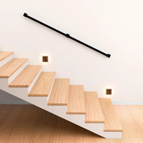 Kickass 7 Ft Indoor Stair Railing Featuring Matte Black Square Tube Handrail With Boss Level Non Slip Grip For Wall Mount Setup Totally Secure For Bathrooms Lofts And Kitchen Steps Rock Solid 500 Lb Rating, mounted along wooden stairs.