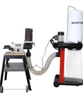 Auto Start Dust Collector Featuring 1.2 HP Motor And 750 CFM Airflow Ships With 5 Ft Flexible Hose setup beside a woodworking machine.