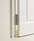 60 Pack Stainless Steel Cabinet Hinges Measuring Two Point Five Inches, Rock Solid Butt Hinges For Drawers Furniture Doors And Workshop Shelving, Silver Shine Pro Grade installed on a white cabinet door.