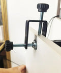 Close-up of 2-Pack Adjustable Drawer Front Mounting Clips And Clamps For Cabinet Hardware Jig attached to a drawer front.
