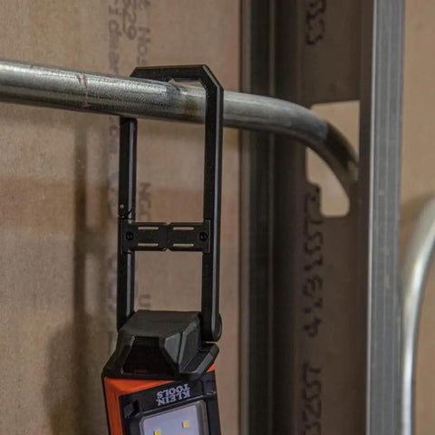 Go To Rechargeable LED Work Light with Kickstand and Carabiner hanging from metal pipe