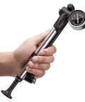 Person holding High Pressure Mountain Bike Shock Pump With Gauge For 300 PSI Front Fork And Rear Suspension No Loss Air Pump Easy Dial Tuning