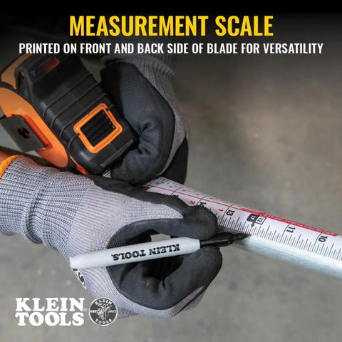 Gloved hands holding 9235 Heavy Duty Magnetic Tape Measure With 16 Foot Reach, measuring on metal surface