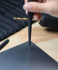 Using a pin punch from the Sixteen Piece Pro Grade Chrome Vanadium Steel Punch And Chisel Set With Storage Pouch For Woodworking.