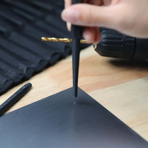 Using a pin punch from the Sixteen Piece Pro Grade Chrome Vanadium Steel Punch And Chisel Set With Storage Pouch For Woodworking.