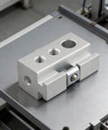 Super Slick Silver Aluminum Camping Table Clip Slider Igt Compatible Multi Hole Adapter on a workbench.