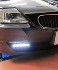 Close-up view of Fits Any Ride LED Daytime Running Light Auto On Off Controller Module Box Relay installed on a car bumper.
