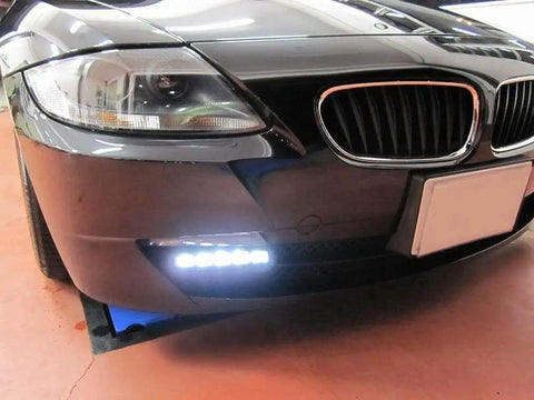 Close-up view of Fits Any Ride LED Daytime Running Light Auto On Off Controller Module Box Relay installed on a car bumper.