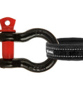 Eight Pack One Half Inch D Ring Shackles, Screw Pin Beefy Heavy Duty Gear For Towing And Off Road Recovery, 2 Ton Working Load Limit And 8 Ton Breaking Strength, Carbon Steel Chain Shackles Clevis Set, close-up of black shackle with red pin connected to strap.