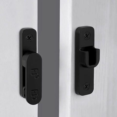 Sturdy Black Zinc Alloy Barn Door Latch With 180 Degree Slide Lock For Wood Doors on a white wooden door panel.