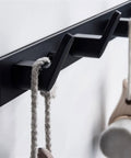 Tough As Nails Wall Mounted Coat Hooks With Slick Black Finish, showcasing hooks holding ropes for bags or coats.