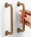 Hand holding Antique Brass Cabinet Pulls 10 Pack With 3-3/4 Inch Hole Centers, Vintage Brass Handles For Cabinets, Drawers, Dressers