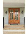 Burlington Two Light Wall Lantern In Oil Rubbed Bronze Finish on porch flanking double wooden doors