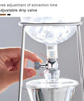 Top Shelf Cold Brew Drip Tower And Ice Coffee Maker With Solid Reusable Filter Dripper showing adjustable drip valve being adjusted.