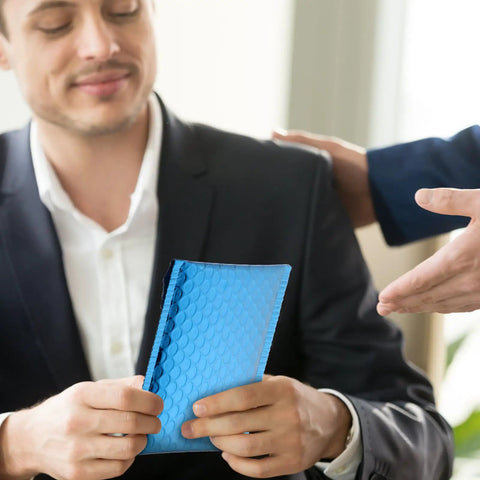 Person holding a Blue Aluminum Film Bubble Mailers 50 Count, Built Tough Padded Envelopes With Self Sealing, Lightweight Shipping Mailers