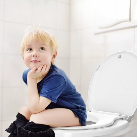 Child sitting on round toilet seat with built-in toddler seat for potty training. Fits adults and kids slow close quiet lid.