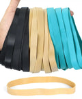 Heavy Duty Thick Rubber Bands Set 36 Pcs Large Wide Ranger Bands Size 107 in black, beige, and blue colors held in hand