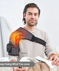 Man using Cozy Heated Shoulder Wrap Massager with cordless design, showcasing fit on right shoulder and adjustable strap in home setting
