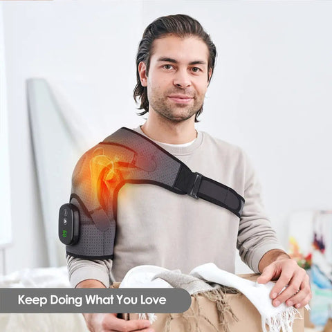 Man using Cozy Heated Shoulder Wrap Massager with cordless design, showcasing fit on right shoulder and adjustable strap in home setting