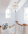 Four Light Wood Beaded Boho Farmhouse Pendant Chandelier With Tassels In White Rustic Bohemia Style in bright stairwell