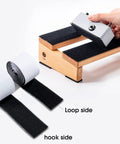 Guitar Pedalboard Velcro Mounting Tape 2m Long By 5cm Wide For Securing Effects Pedals with hand applying pedal on board.