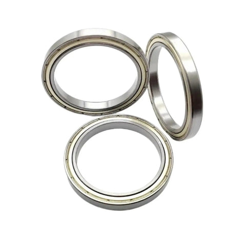 Three High Precision Stainless Steel Deep Groove Ball Bearings With Sealed Shielding, showcasing their industrial grade durability.