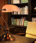White Matte Glass Banker Desk Lamp in Retro Bronze Finish With Rotatable Lampshade, Pull Switch, in an office setting