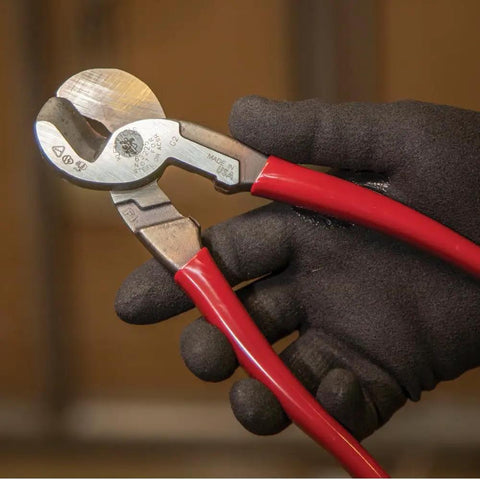 Beefy 9-Inch High Leverage Cable Cutter For Aluminum Copper And 100-Pair Communications Cable Made In USA Precision One-Hand Shear Cable-Gripping Jaws Built For Tight Spaces held in a gloved hand