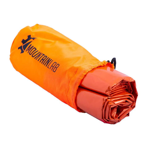 Ultra Compact Emergency Blanket For Outdoor Adventures That Keeps You Warm With Heat Reflective Tech, rolled in orange bag