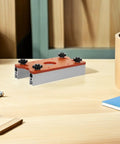 Tough Aluminum Router Table Insert Plate Dead Center Alignment Tight Grip Locks No Sweat Mounting For The Woodshop Crew on a workbench.