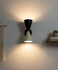 Mid-Century Two-Tone Cone Wall Sconce Light - Black & White Dual Funnel Wall Mounted Lamp with Gold Accent Ring - Up and Down Wall Lighting Fixture for Living Room & Bedroom on a white wall.