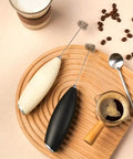 Top Tier Handheld Milk Frother Packs Serious Oomph For Crafting Silky Foam On The Fly with black and white designs.