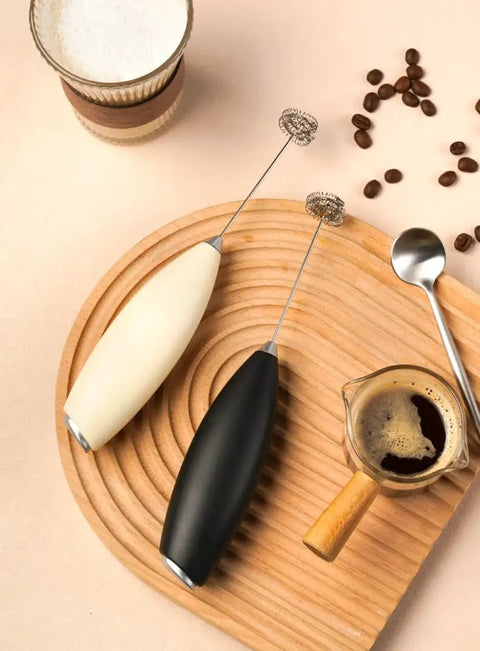Top Tier Handheld Milk Frother Packs Serious Oomph For Crafting Silky Foam On The Fly with black and white designs.