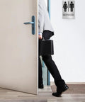Person entering door with Unisex Restroom Sign For Business With ADA Braille, 9x6 Inch Self Adhesive Door Or Wall Sign visible on wall