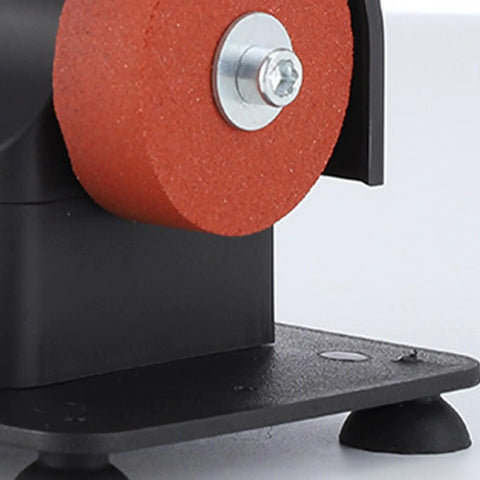 Close-up of red abrasive wheel on Smooth Operator Mini Bench Grinder For Home Shop Deburring Sharpening And Steel Polishing.