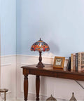 Dragonfly Tiffany Style Stained Glass Table Lamp With 12 Inch Wide Shade And Metal Base, 6 Dragonflies On Lampshade, Bold Orange And Blue Color, 18 Inch Tall, Uses 60W E26 Bulb, Warm Cozy Glow on wooden table near books and decor
