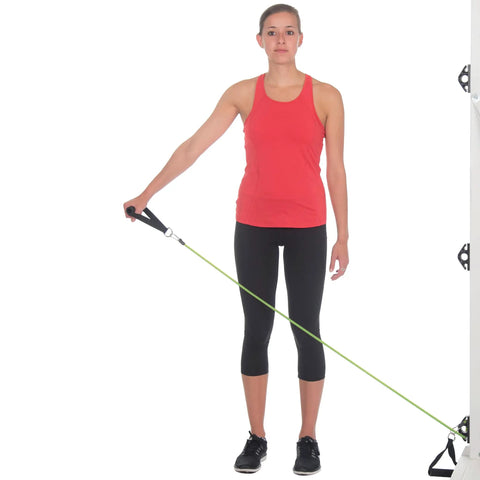 Woman using Stellar Resistance Band Wall Anchor Kit For Home Gym And Physical Therapy with green resistance band.