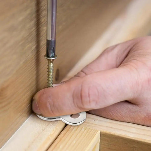 Close-up of Heavy Duty Figure Eight Table Connectors installation with iron clip and screw on wood, ensuring tight furniture assembly.