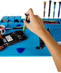 Hands using tools on Pro Grade Silicone Repair Mat With Magnetic Features For Electronics Soldering, Two ESD Tweezers, Wrist Strap