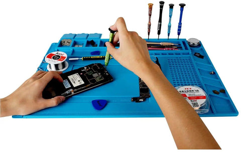 Hands using tools on Pro Grade Silicone Repair Mat With Magnetic Features For Electronics Soldering, Two ESD Tweezers, Wrist Strap
