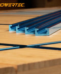Double Cut Profile Universal T Track Kit With Bi Directional Short Stops Four 48 Inch T Tracks And Four Stop Blocks For Woodworking Jigs And Fixtures Sanding And Routing Pro Grade Easy Install, blue aluminum T-track on wood bench