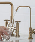 Urbix Standalone On-Demand Lead-Free Kitchen Water Filter Faucet in Brushed Gold pouring water into glass