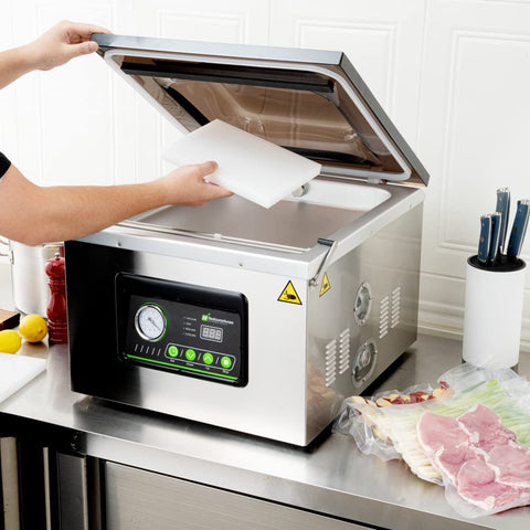 Pro Grade Chamber Vacuum Sealer Packs A Solid Punch With Sturdy 16 Inch Seal Bar And Whisper Quiet Motor, user adding a bag.