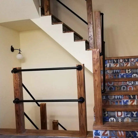Heavy Duty Rustic Industrial Pipe Railing And Beefy Wrought Iron Handrail For Porches Decks Stairs delivering rock solid support on a staircase.